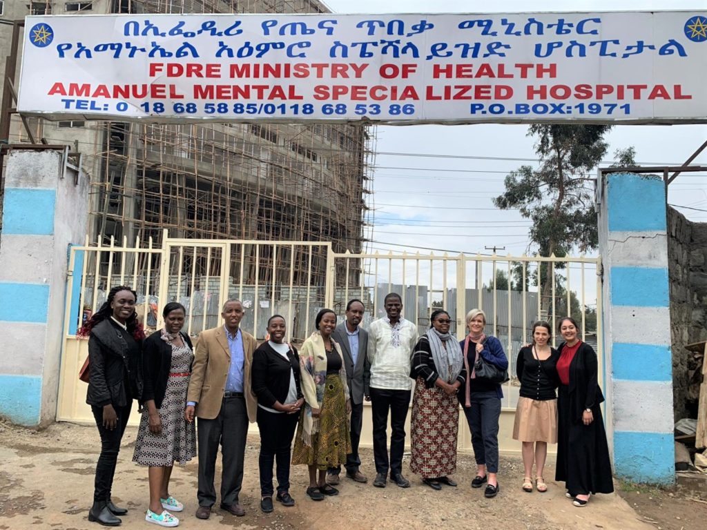 The AEWG members standing under the entrance to Amanuel mental Specialized hospital (Addis Ababa's psychiatric hopsital)